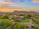 Luxury home with pool and mountain views at sunset at 5 Promontory Ridge Dr, Las Vegas, NV 89135