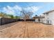 Large backyard with sand and tree at 5625 Reiter Ave, Las Vegas, NV 89108