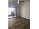 Living room with wood-look floors and sliding door to patio at 4400 S Jones Blvd # 1009, Las Vegas, NV 89103