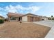 House exterior with a three car garage and desert landscaping at 5301 Clouds Rest Ave, Las Vegas, NV 89108