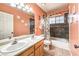 Bathroom with double sinks, tiled shower and tub, and tile floor at 5312 Bright Sun Ct, Las Vegas, NV 89130