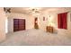 Spacious main bedroom with built-in bookshelves, plush carpet, and a ceiling fan at 5312 Bright Sun Ct, Las Vegas, NV 89130