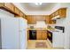 Galley kitchen with wood cabinets and appliances at 518 Elm St # H, Boulder City, NV 89005