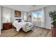 Spacious bedroom with plush bedding, wood floors, and large windows at 476 Morro Strand Ave, Las Vegas, NV 89138