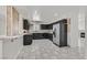 Kitchen with dark cabinetry, stainless steel appliances, and granite countertops at 3825 Pink Frost Dr, North Las Vegas, NV 89032