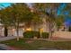 Two-story house with a beige exterior, two-car garage, and landscaping at 10078 Ivy Patch St, Las Vegas, NV 89183