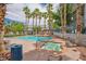 Community pool with a hot tub, seating area, and surrounding palm trees at 2201 Ramsgate Dr # 424, Henderson, NV 89074