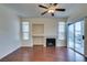 Living room with fireplace, ceiling fan, wood-look floors, and sliding glass door to balcony at 2201 Ramsgate Dr # 424, Henderson, NV 89074