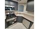 Kitchen area with stainless steel appliances and dark gray cabinets at 1621 Sandecker Ct # 104, Las Vegas, NV 89146