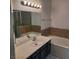 Bathroom with dark vanity and bathtub at 1621 Sandecker Ct # 104, Las Vegas, NV 89146