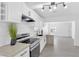 Modern kitchen with white cabinets, stainless steel appliances, and wood island at 1608 E Mcdonald Ave, North Las Vegas, NV 89030