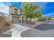 Two-story townhome with attached garage and landscaped front yard at 7321 Halsey Ct, Las Vegas, NV 89129