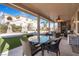 Covered patio with seating area overlooking the pool and backyard at 7108 Horseshoe Cliff Ave, Las Vegas, NV 89113