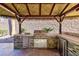 Outdoor kitchen with stainless steel appliances and stonework at 2820 Sisteron Ct, Henderson, NV 89044