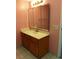 Bathroom with wood vanity, tiled floor and mirrored medicine cabinet at 3578 Newland Ave, Las Vegas, NV 89121