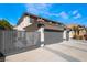 Two-story house with three-car garage and gated driveway at 7869 Salt Spray Ct, Las Vegas, NV 89139