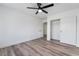 Bright bedroom with wood-look floors and ceiling fan at 7869 Salt Spray Ct, Las Vegas, NV 89139