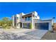 Modern two-story home with a glass garage door at 7859 W Wigwam Ave, Las Vegas, NV 89113