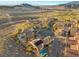 Aerial view of house with pool, solar panels, and desert landscape at 1159 Calcione Dr, Henderson, NV 89011