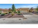 Single-story home with a two-car garage and desert landscaping at 9833 Villa Ridge Dr, Las Vegas, NV 89134