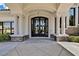 Elegant entryway with ornate iron doors and columns at 22 Augusta Canyon Way, Las Vegas, NV 89141