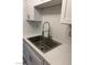 Modern kitchen with white cabinets, stainless steel sink, and faucet at 512 N 1St St, Las Vegas, NV 89101