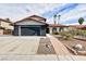 Two-story house with a black garage door and landscaped front yard at 5376 Modena Dr, Las Vegas, NV 89120