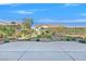 Landscaped backyard with a paved patio and desert landscaping at 10032 Hope Island Dr, Las Vegas, NV 89134