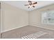 Well-lit bedroom with ceiling fan and plush carpeting at 10032 Hope Island Dr, Las Vegas, NV 89134