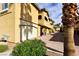 Building exterior showcasing attached garages and desert landscaping at 1605 Crimson Hills Dr # 204, Las Vegas, NV 89128