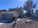 Two-story house with a two-car garage and rock landscaping at 8817 Borla Dr, Las Vegas, NV 89117