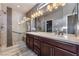 Elegant bathroom with dual vanity, large mirror, and a walk-in shower at 5709 Pleasant Palms St, North Las Vegas, NV 89081