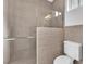 Bathroom with a walk-in shower, toilet, and tiled walls at 4045 W Ford Ave, Las Vegas, NV 89139