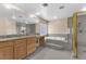 Main bathroom with walk-in shower, soaking tub, double vanity, and granite countertop at 4045 W Ford Ave, Las Vegas, NV 89139