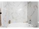 Bathroom features marble shower/tub combo and neutral tones at 7813 Paper Flower Ct, Las Vegas, NV 89128