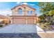 Two-story house with a two-car garage and landscaped front yard at 7813 Paper Flower Ct, Las Vegas, NV 89128