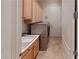 Bright laundry room with washer, dryer, and ample cabinetry at 2309 Aztec Ruin Way, Henderson, NV 89044