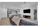 Open concept living space with gray sectional sofa and kitchen island at 10772 Briset Ct, Las Vegas, NV 89166