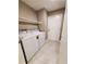 Laundry room with washer, dryer, and built-in shelving at 2678 Aracatuba Ave, Las Vegas, NV 89121