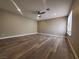 Spacious living room featuring wood-look flooring and ceiling fan at 2678 Aracatuba Ave, Las Vegas, NV 89121