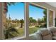 Expansive window view of a lush green backyard with a golf course beyond at 11534 Glowing Sunset Ln, Las Vegas, NV 89135