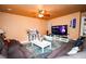 Relaxing living room with comfortable seating, a large TV, and a coffee table at 564 Campus Oaks Ct, Las Vegas, NV 89183