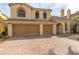 Two-story house with a three-car garage and brick driveway at 10052 Baystone St, Las Vegas, NV 89141