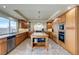 Large kitchen with an island, stainless steel appliances, and light wood cabinets at 10052 Baystone St, Las Vegas, NV 89141