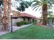 Tan stucco condo building with red tile roof, and lush green lawn at 744 Apple Tree Ct, Henderson, NV 89014