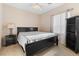 Well-lit bedroom with a queen-size bed and built-in shelving at 11132 Ferragamo Ct, Las Vegas, NV 89141