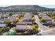 Aerial view of houses with a pool and mountain backdrop at 11132 Ferragamo Ct, Las Vegas, NV 89141