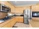 Kitchen with wood cabinets and stainless steel appliances at 11132 Ferragamo Ct, Las Vegas, NV 89141