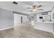 Open living area with grey walls, hardwood floors, and views into the kitchen and staircase at 1728 Griffith Ave, Las Vegas, NV 89104