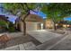 Desert home with two-car garage, front landscaping, and a neutral color palette at 3647 Waynesvill St, Las Vegas, NV 89122